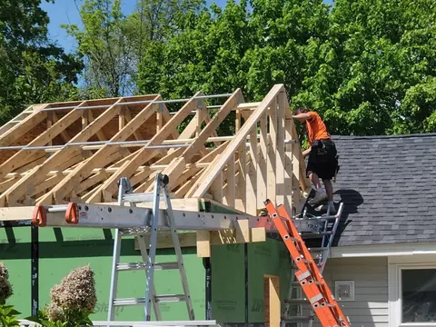 A J & J Building & Restoration carpenter framing a new roof